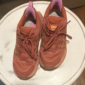 Hoka Women's athletic sneakers. Low-hiking shoes